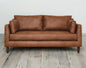 https://www.livingstore.cl/wp-content/uploads/2023/12/sofa-napoles-cuero-bonded-70-whisky-frente-amb.jpg